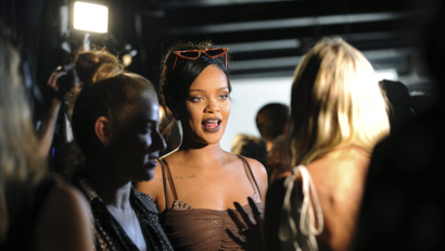 Rihanna speaking to journalists after showing her Savage x Fenty line on the runway