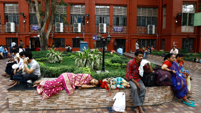 Relatives of patients rest in the premises of a government-run hospital in Kolkata