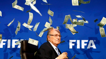British comedian known as Lee Nelson (unseen) throws banknotes at FIFA President Sepp Blatter as he arrives for a news conference after the Extraordinary FIFA Executive Committee Meeting at the FIFA headquarters in Zurich, Switzerland July 20, 2015. World football's troubled governing body FIFA will vote for a new president, to replace Sepp Blatter, at a special congress to be held on February 26 in Zurich, the organisation said on Monday.