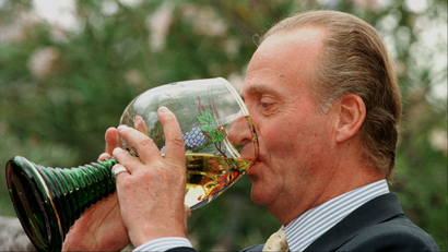 A man drinking from an enormous wine glass.