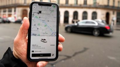 A photo Illustration shows the Uber application on a mobile phone in in central Paris, France.