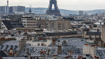 A view shows city rooftops and chimney stacks of residential apartment buildings near the Eiffel Tower in Paris