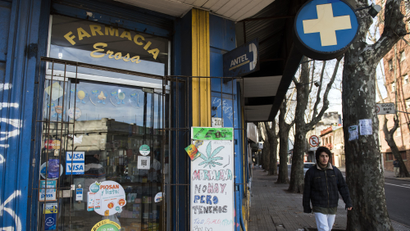 A pharmacy displays a sign at the front door telling clients that they do not have marijuana for sale