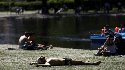 People sunbathe in hot weather in Regent's Park in London