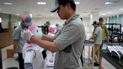 A worker puts finishing touches to an iPal social robot, designed by AvatarMind, at an assembly plant in Suzhou, Jiangsu province, China July 4, 2018. Designed to offer education, care and companionship to children and the elderly, the 3.5-feet tall humanoid robots come in two genders and can tell stories, take photos and deliver educational or promotional content.