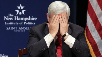 Newt Gingrich holds his head in his hands.