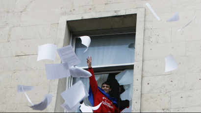 A man throws documents out of a window of the parliament building in Chisinau, Moldova.