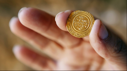 holding gold coin