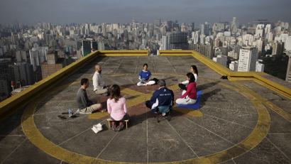 People meditate on the helipad of Copan building to celebrate "World Health Day" in downtown Sao Paulo