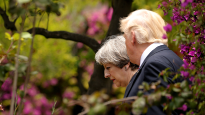 U.S. President Donald Trump talks to Britain's Prime Minister Theresa May at the G7 Summit in Taormina, Sicily