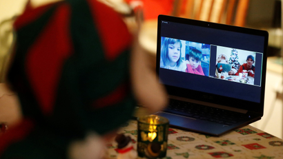 Children are seen on a screen as Santa interacts with them by video, amid the COVID-19 outbreak in Budapest
