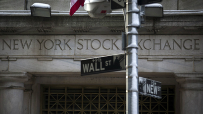The Wall St. sign is seen outside the door to the New York Stock Exchange in New York's financial district.