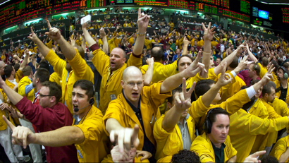 Traders react in a trading pit at the Chicago Mercantile Exchange