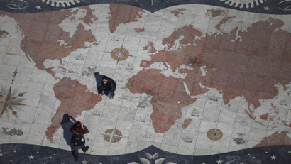 A man is photographed on a square decorated with a giant world map, with marks showing former Portuguese colonies, in Lisbon March 6, 2012. Portugal flourished as a global power with explorers like Vasco da Gama and Pedro Alvares Cabral building an empire which lasted for 600 years. Now a new wave of adventurers is once again seeking work, and hopefully fortune, elsewhere. Emigrating is fast becoming a preferred option for many seeking a decent living as their bailed-out economy suffers under debt, low growth and poor competitiveness. Portugal's booming ex-colonies in Africa and Brazil are a natural choice. Picture taken March 6, 2012.