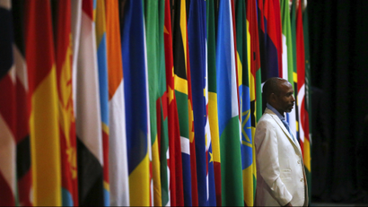A visitor stands in front of a row of African flags in Johannesburg, South Africa.