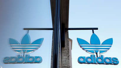 The Adidas logo is mirrored in the window of one of its stores in Germany