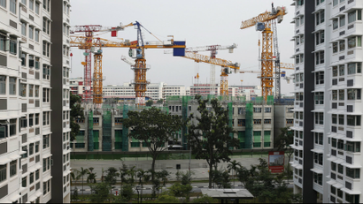 A view of a construction site of a public residential apartment estate next to completed estates in Singapore.