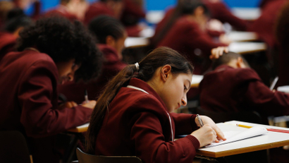 Pupils take a GCSE mathematics exam at the Harris Academy South Norwood in south east London, March 2, 2012