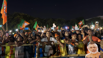 People listen to Narendra Modi in Dum Dum, Kolkata, on May 16.