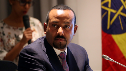Ethiopia's prime minister dressed in a suit, staring directly into the camera with a stern expression on his face.