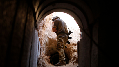 An Israeli soldier looks at a tunnel exposed by the Israeli military near Kibbutz Ein Hashlosha, just outside the southern Gaza Strip October 13, 2013.