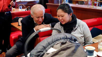U.S. Vice President Joe Biden leans in to look at a baby during a stop at a restaurant in Sterling, Virginia.