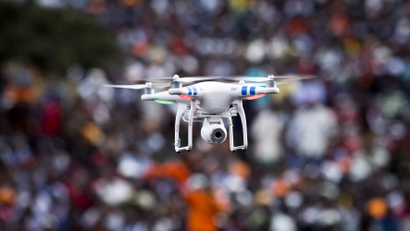 A local television channel uses a video-equipped drone to film a rally welcoming Kenyan opposition leader Raila Odinga back to the country, in downtown Nairobi, Kenya Saturday, May 31, 2014. Odinga, who narrowly lost the last election to current President Uhuru Kenyatta, returned to Kenya Saturday following a three month sabbatical in the United States and his arrival was greeted by tens of thousands of his supporters at a rally in downtown Nairobi.