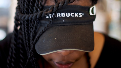 Starbucks worker with a visor 