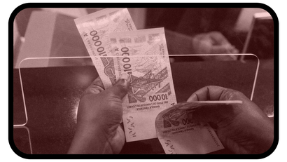 Photo of person shuffling cash in Senegal bank.