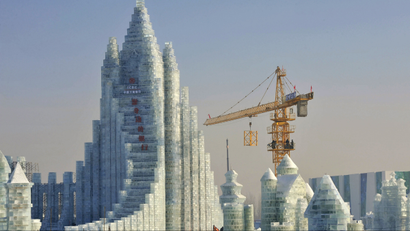 Workers and a crane are seen next to a newly-built ice sculpture of a castle ahead of the 30th Harbin Ice and Snow Festival, in Harbin, Heilongjiang province December 27, 2013. According to the festival organizers, nearly 10,000 workers were employed to build the ice and snow sculptures, which require about 180,000 square metres of ice and 150,000 square metres of snow. The festival kicks off on January 5, 2014.