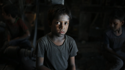 In this Sunday, June 12, 2016, photo, Ridoy, 7, poses for a portrait as he works at a factory that makes metal utensils in Dhaka, Bangladesh. The World Day Against Child Labor, which was initiated in 2002 by the International Labor Organization to highlight the plight of child laborers, is observed across the world on June 12. (AP Photo/A.M. Ahad)