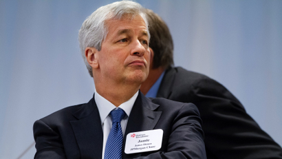 JPMorgan Chase Chairman and CEO Jamie Dimon listens as President Barack Obama speaks to leading CEOs to discuss ways to promote the economy and create jobs during the president's last two years in office, Wednesday, Dec. 3, 2014, at the Business Roundtable Headquarters in Washington.