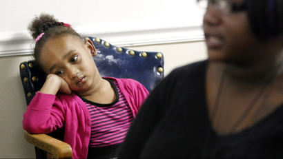 Kourtney Marie Davis, 3, sits in a chair as her mother Angelic Davis talks about being homeless during an interview in Dallas, Monday, Dec. 12, 2011. The recession and unemployment have created a “manmade disaster” that has caused a steady increase in the number of homeless children in the state. (AP Photo/LM Otero)