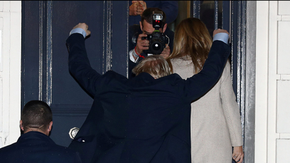 Boris Johnson reacts as he and his girlfriend Carrie Symonds arrive at the Conservative Party's headquarters