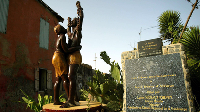 A statue commemorating freedom from slavery stands outside the Slave House on Goree Island, Senegal August 17, 2006. An unknown number of slaves were shipped from here to French colonies in the Caribbean between the mid-16th and 19th centuries. The International Day for the Remembrance of the Slave Trade and its Abolition is celebrated on August 23.