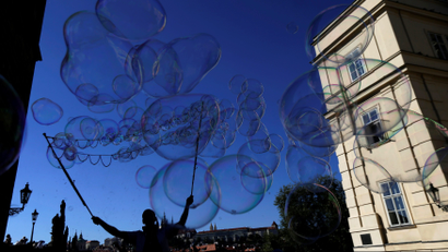 A street artist performs with soap bubbles in Prague