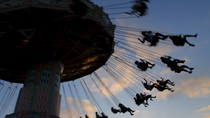 Fair-goers enjoy a ride as the sun sets at the annual San Diego County Fair in Del Mar, California
