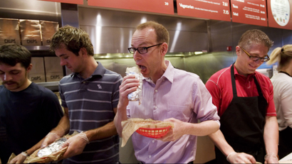 Man eating burrito at Chipotle event
