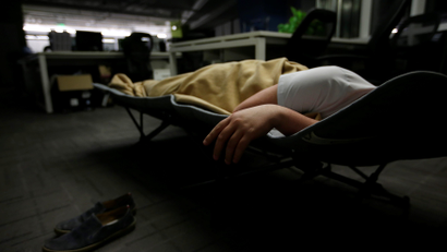 A man sleeps at the office in China