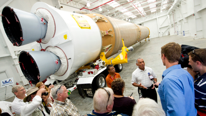 NASA Administrator Charles Bolden, stands in front of the Atlas V first stage booster while taking questions from the media, Wednesday, Sept. 7, 2011, at the Cape Canaveral Air Force Station in Cape Canaveral, Fla. The booster will help send NASA's Mars Science Laboratory Curiosity rover to Mars later this year.