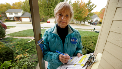 In this photo taken Oct. 5, 2012, President Barack Obama volunteer Marilynn Wadden, of Des Moines, Iowa, stands outside her home in Des Moines. Wadden rang more than a dozen doorbells in her first hour canvassing a tidy neighborhood before stopping to take stock of her progress. Only a handful of voters were home, and, of them, only one agreed to have a ballot mailed to him so he can vote early. “I wouldn't do this for pay. It'd be too discouraging,” said the 70-year-old retired principal.