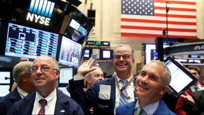 Traders react while working on the floor of the New York Stock Exchange