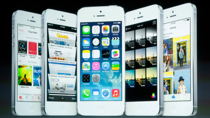 Screenshots of the iOS7 are seen on the screen during Apple Inc's media event in Cupertino, California September 10, 2013.