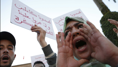 A Moroccan shouts as thousands of Moroccans protest against the death of Mouhcine Fikri last Friday, with placard reading "mash us of respect us", in the northern city of Hoceima in Rabat, Morocco, Sunday, Oct. 30, 2016. Crowds of Moroccans are protesting, seemingly incensed by the death of a fisherman crushed to death in a garbage truck.