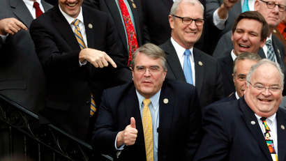 U.S. Rep. John Culberson of Texas gives a thumbs up to U.S. President Donald Trump (bottom) as he stands with fellow Republican members of Congress as he celebrates after the U.S. Congress passed sweeping tax overhaul legislation, on the South Lawn of the White House in Washington, U.S., December 20, 2017.