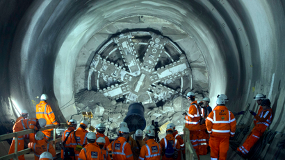 Workers view the tunnel boring machine Victoria as it breaks into the eastern end of the Liverpool Street Crossrail station in London, March 10, 2015. Liverpool Street is one of 10 new Crossrail stations being built in London, as part of a new railway line due to be operational in 2019.