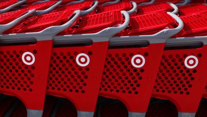 Target shopping carts await customers outside a Target department store in Encinitas, California February 21, 2012. Target will report earnings this week. REUTERS/Mike Blake (UNITED STATES - Tags: BUSINESS)