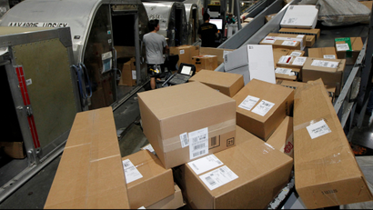 United Parcel Service employees load packages at the UPS Worldport International Hub in Louisville, Kentucky