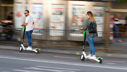 Photo of people riding Lime scooters.