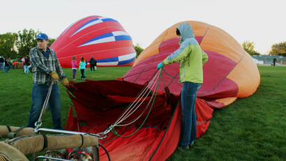 Crew members inflate a hot air balloon during the 2014 Albuquerque International Balloon Fiesta.